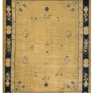 A golden yellow rug with scattered small navy patterns and an ornate dark blue border.