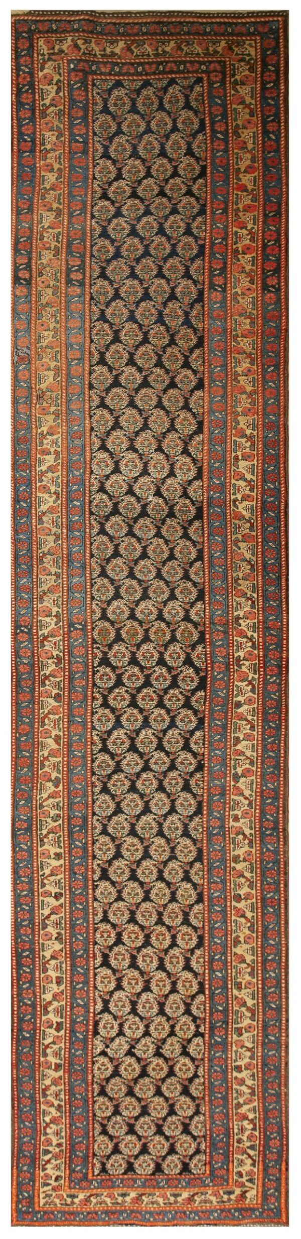 Runner rug with a dark repeating medallion center and wide borders patterned in rust, beige, and blue.