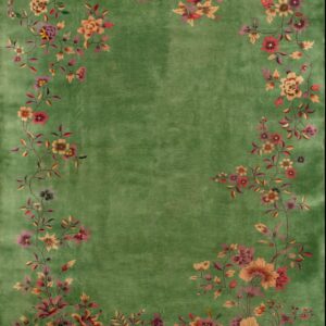 Green rug with a distinct, multicolored floral vine border surrounding a solid center field.