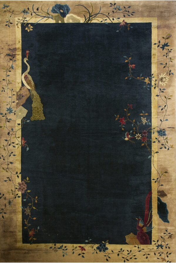 Navy blue rug with a tan border framed by climbing vines, colorful flowers, and corner bird designs.