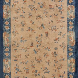 Beige rug featuring scattered blue and terracotta floral and scenic motifs within a wide solid navy blue border.