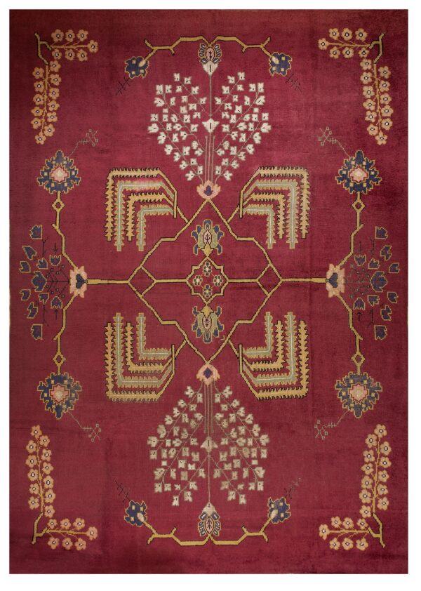 Deep burgundy rug featuring a symmetrical pattern of stylized trees, geometric elements, and floral medallions.