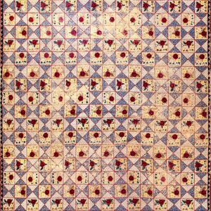 Cream, red, and blue geometric rug with a floral patchwork pattern framed by dark borders.