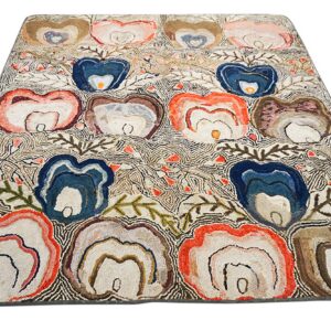 Textured rug with organic, layered blue, coral, and brown floral motifs on a fine-lined white background.