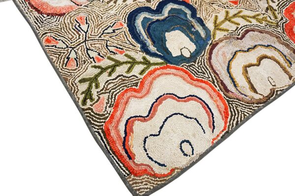 High-texture rug featuring abstract organic floral designs in coral, blue, brown, and cream colors.