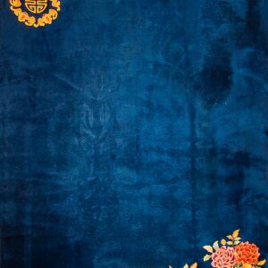 Dark blue rug with subtle texture, featuring gold corner iconography and bright orange and yellow flowers.