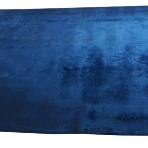 A deep blue plush rug with colorful floral motifs and an orange stylized symbol in opposing corners.