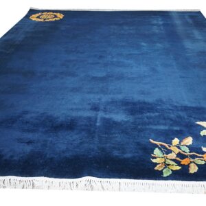 Velvety navy blue rug featuring a corner arrangement of colorful pink, orange, and yellow flowers.