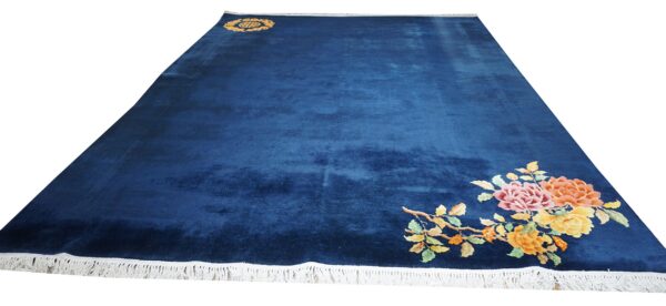 Velvety navy blue rug featuring a corner arrangement of colorful pink, orange, and yellow flowers.