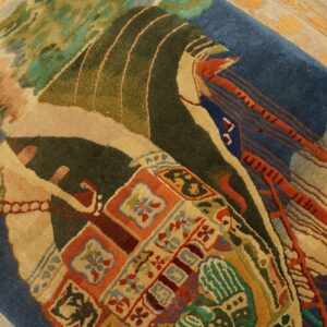 Close-up of a high-pile rug with abstract patterns in blue, tan, olive, and terracotta on wood floor.