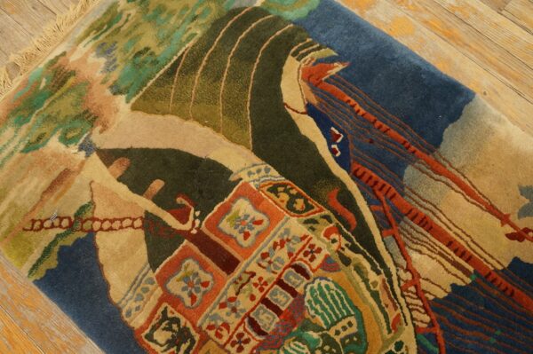 Close-up of a high-pile rug with abstract patterns in blue, tan, olive, and terracotta on wood floor.