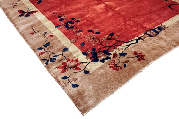 Red central field rug with tan border featuring intricate blue and red floral and butterfly designs.