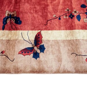 A close-up of a rug featuring red, ivory, and taupe bands with floral and butterfly patterns.