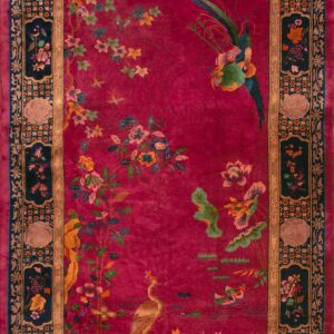 Tall red rug featuring birds and flowers surrounded by a detailed navy and gold frame.