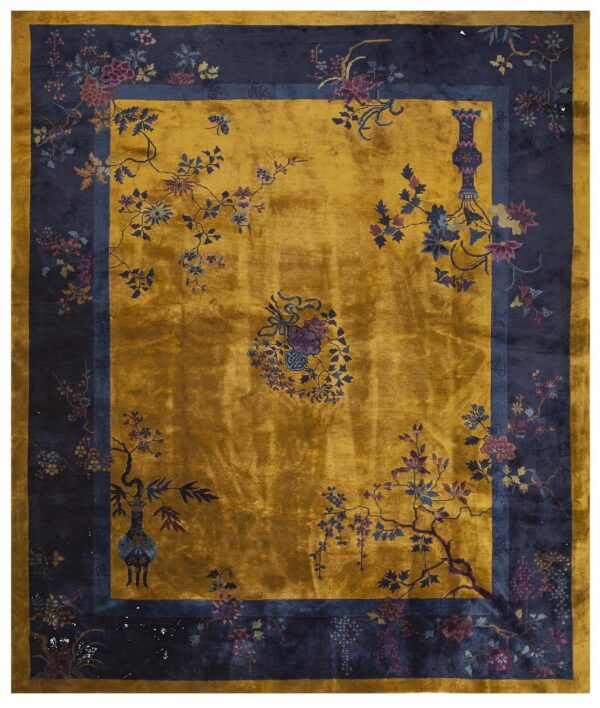 Rich gold, high-sheen rug with a wide navy border featuring colorful ornate floral patterns.