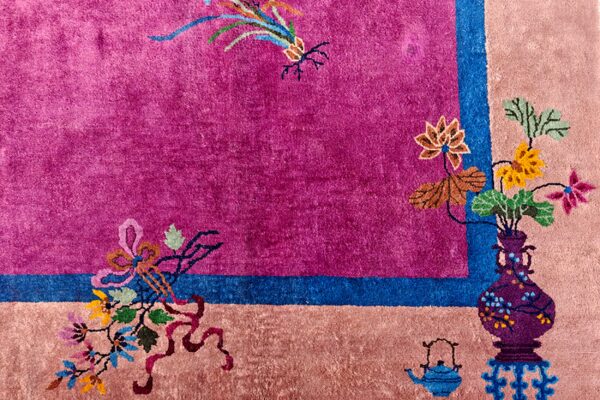 Bright magenta field bordered by pink and blue stripes, featuring stylized floral, vase, and teapot motifs.