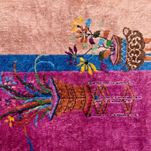 High-pile rug section in pink, blue, and magenta, detailed with contrasting floral and ornate vase motifs.