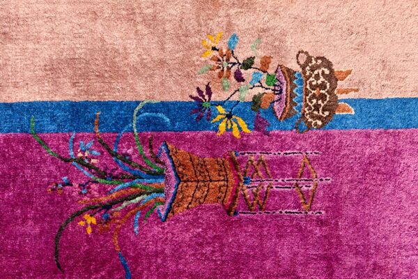 High-pile rug section in pink, blue, and magenta, detailed with contrasting floral and ornate vase motifs.