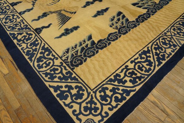 Tan and navy high-pile rug displays stylized clouds and a large central creature motif on wood floors.