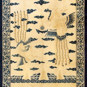 Beige rug with a navy blue scrolling vine border, featuring stylized birds, clouds, and waves.