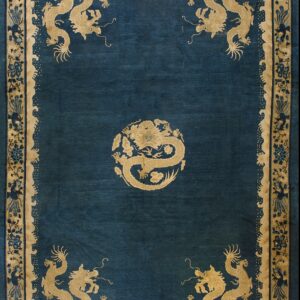 Deep blue rug field bordered by beige and gold, featuring five prominent stylized dragon figures.