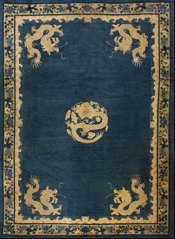 Deep blue rug field bordered by beige and gold, featuring five prominent stylized dragon figures.