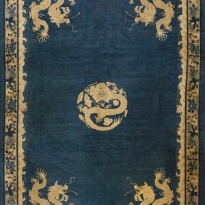 Teal rug with gold dragon designs in the center and corners, framed by a floral and vine border.