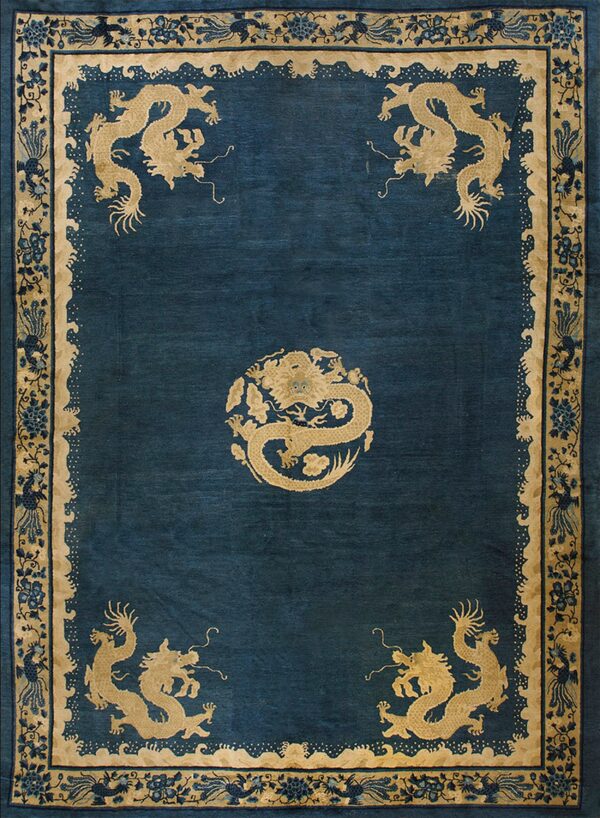 Teal rug with gold dragon designs in the center and corners, framed by a floral and vine border.