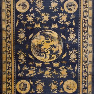 Deep blue rug with gold medallion and scattered botanicals, framed by geometric and floral borders.