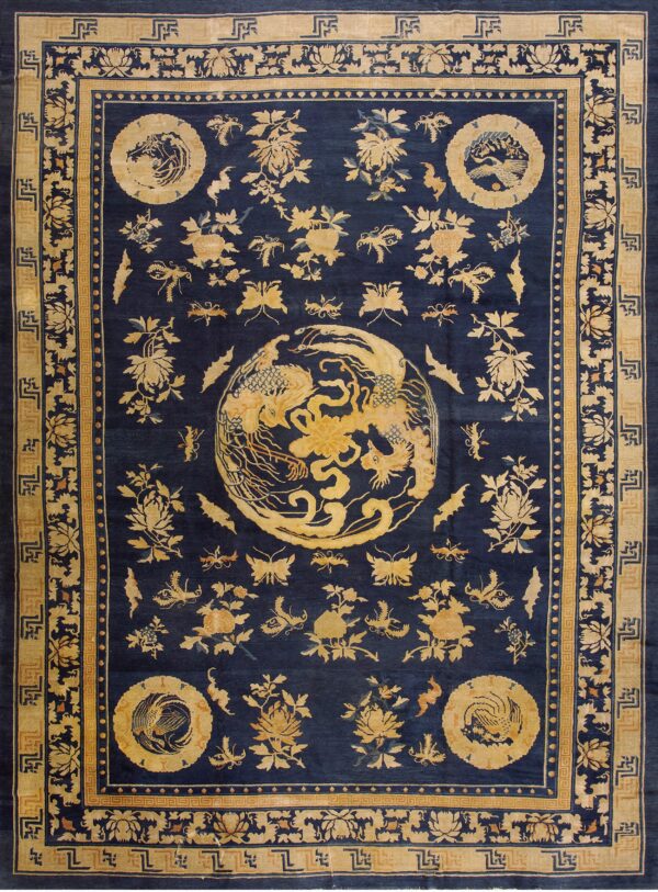 Deep blue rug with gold medallion and scattered botanicals, framed by geometric and floral borders.