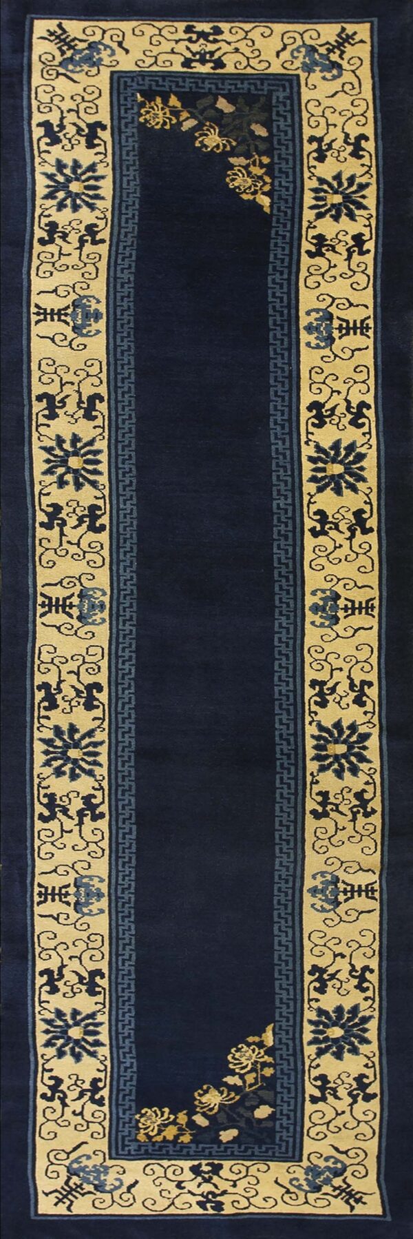 Dark blue runner rug with wide tan borders featuring stylized blue floral and scroll motifs.
