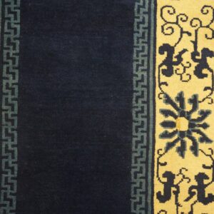 Navy blue runner rug with yellow borders featuring dark floral and teal geometric patterns on wood floor.
