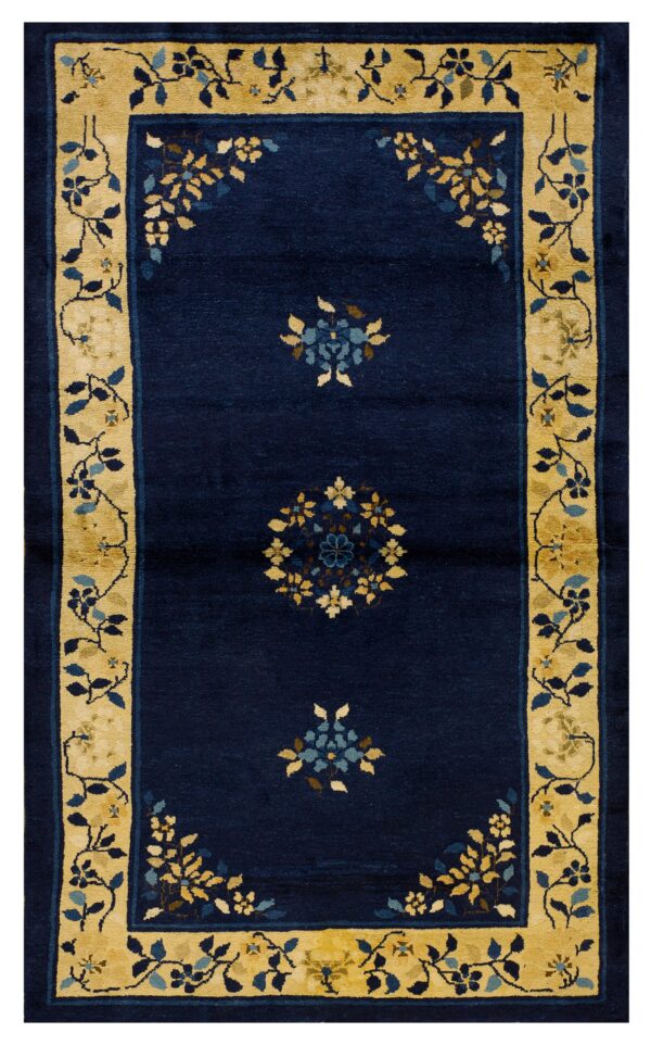 Dark blue rug with ochre floral borders and repeating blue and yellow stylized central medallions.