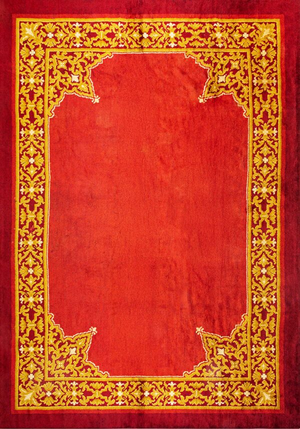 Ornate red and gold rug with a solid crimson field bordered by complex yellow scrollwork.