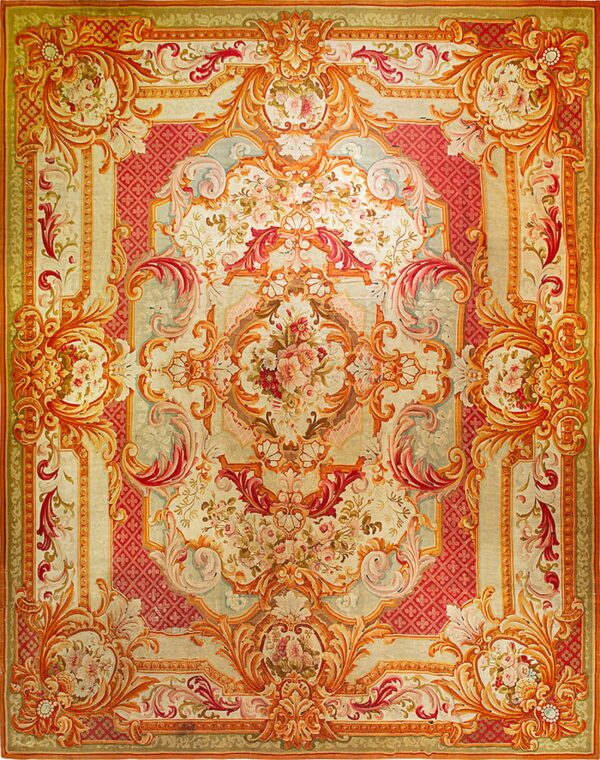 Symmetrical baroque rug featuring large floral bouquets, heavy scrollwork, and rich coral and cream tones.
