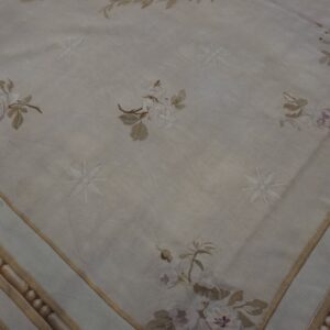 Cream and beige rug with soft floral and geometric patterns, featuring a very low pile texture.