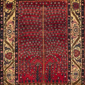 Red rug featuring a central Tree of Life pattern framed by intricate multicolored floral borders on a gold ground.
