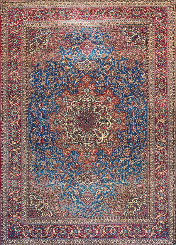 Ornate traditional rug featuring a deep blue field, red border, and complex floral medallion design.