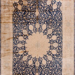 Distressed rug with a central beige medallion, surrounded by a navy blue floral mihrab design and beige spandrels.