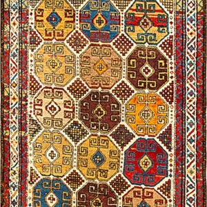 Runner rug with repeating multicolored octagonal medallions in jewel tones of red, blue, gold, and brown.