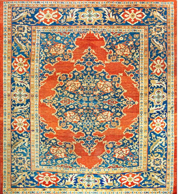 Blue and rust traditional rug with an elaborate central medallion and ornate floral borders.