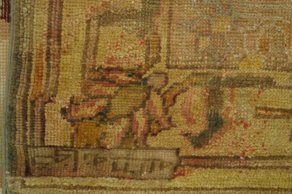 Antique oversized oushak turkish medallion knotted rug 5 Coarse pile rug detail featuring abstract patterns in mustard yellow, brown, and speckled red.