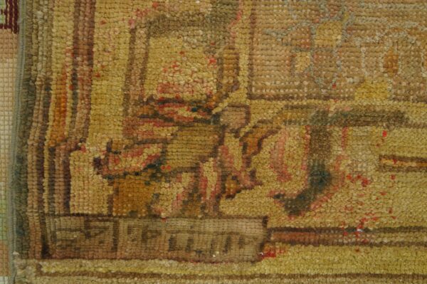 Antique oversized oushak turkish medallion knotted rug 6 Detailed close-up of a textured rug with knots in golden yellow, brown, and muted red patterns.