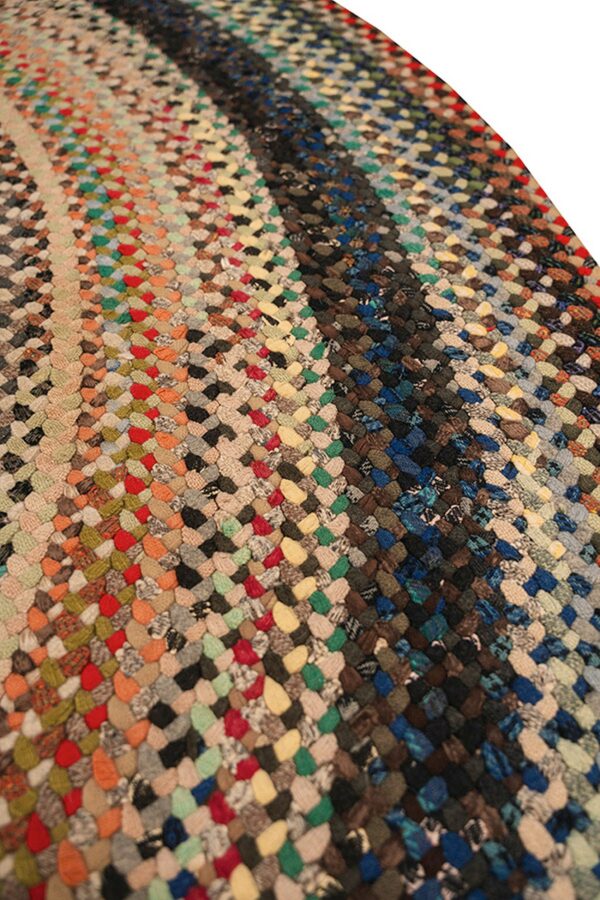 Braided rug featuring multicolored woven segments in stripes of bright and dark, earthy colors.