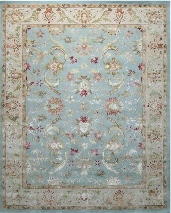 Light blue rug with an ornate floral pattern featuring a wide tan border and multicolored accents.