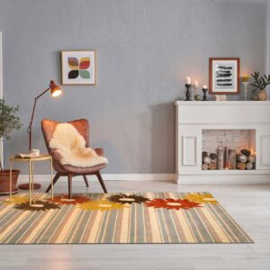 The colorful striped and floral rug anchors a gray reading nook with a chair and fireplace.