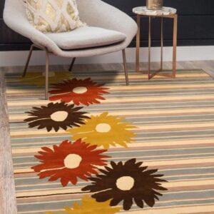 A striped rug featuring large brown, orange, and yellow floral shapes is under a gray chair and side table.