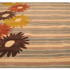 Striped rug with large dark brown, orange, and gold flowers on a cream and dusty grey ground.