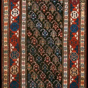 Dark geometric runner rug featuring a black center field with stylized patterns and wide borders in red, blue, and cream.