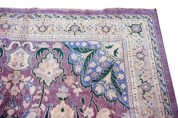 Ornate purple rug detail showing cream borders and dense floral motifs in blue and green.